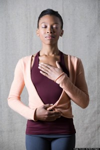 Women breathing deeply, touching chest and abdomen