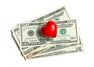 top view of red heart of stone on american dollars on white background